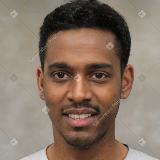 Joyful black young-adult male with short  black hair and brown eyes