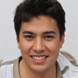 Joyful asian young-adult male with short  brown hair and brown eyes