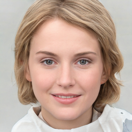 Joyful white young-adult female with medium  brown hair and blue eyes