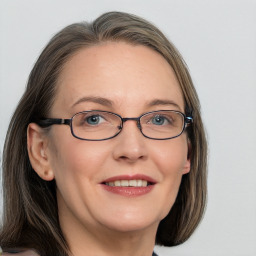 Joyful white adult female with medium  brown hair and grey eyes