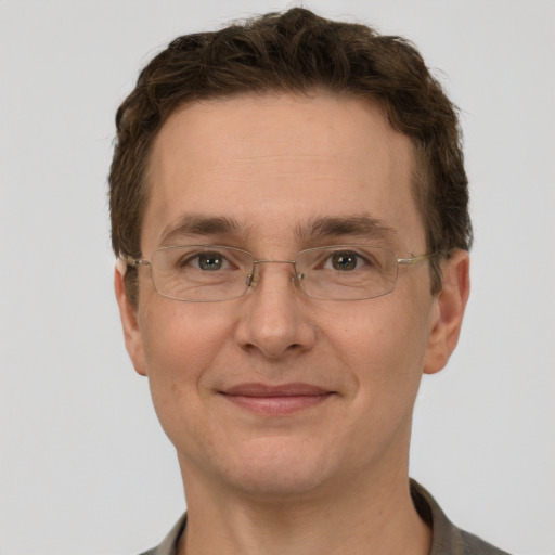 Joyful white adult male with short  brown hair and grey eyes