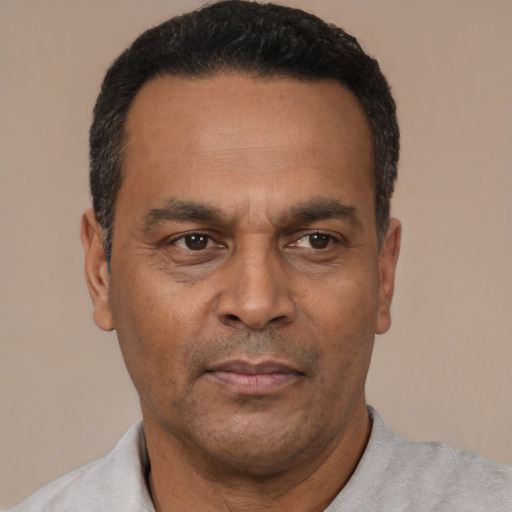 Neutral latino adult male with short  black hair and brown eyes