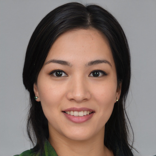 Joyful asian young-adult female with long  black hair and brown eyes