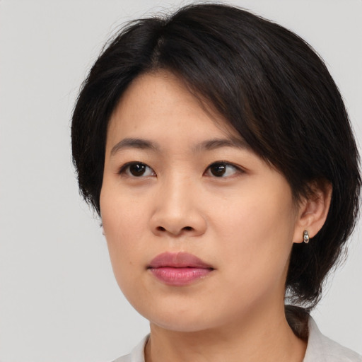 Neutral asian young-adult female with medium  brown hair and brown eyes