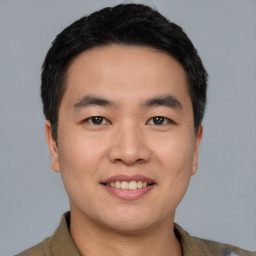 Joyful asian young-adult male with short  black hair and brown eyes