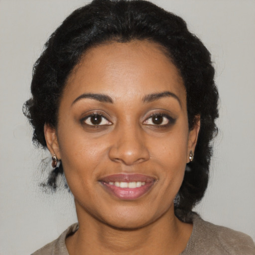 Joyful black young-adult female with medium  brown hair and brown eyes