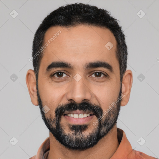 Joyful latino young-adult male with short  black hair and brown eyes