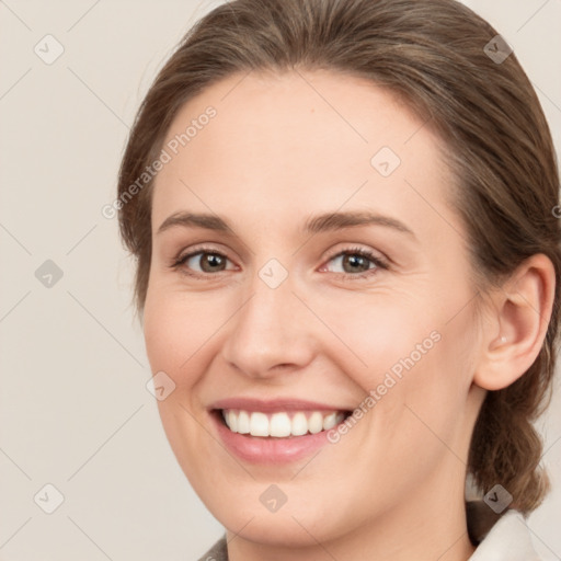 Joyful white young-adult female with medium  brown hair and green eyes