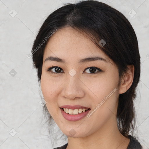 Joyful asian young-adult female with medium  brown hair and brown eyes