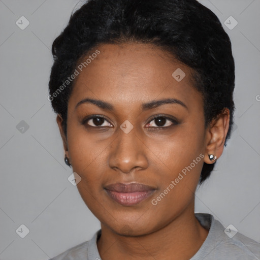 Joyful black young-adult female with short  black hair and brown eyes