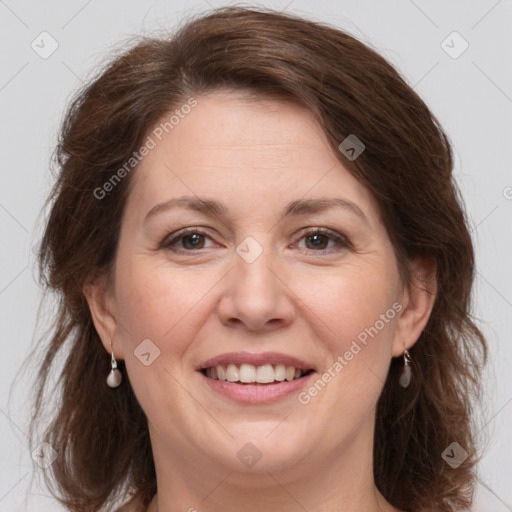 Joyful white adult female with medium  brown hair and grey eyes