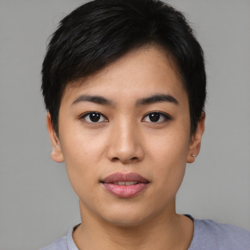 Joyful asian young-adult female with short  black hair and brown eyes
