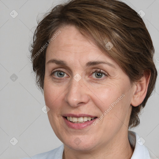 Joyful white adult female with medium  brown hair and grey eyes