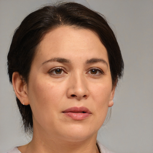 Joyful white adult female with medium  brown hair and brown eyes