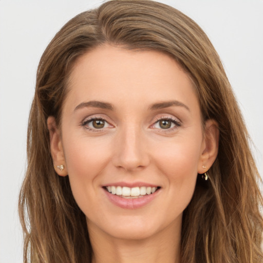 Joyful white young-adult female with long  brown hair and brown eyes