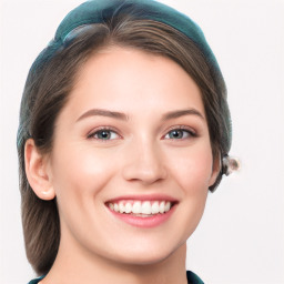 Joyful white young-adult female with long  brown hair and blue eyes