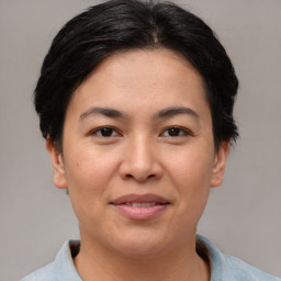 Joyful asian young-adult female with short  brown hair and brown eyes