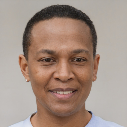 Joyful latino adult male with short  brown hair and brown eyes