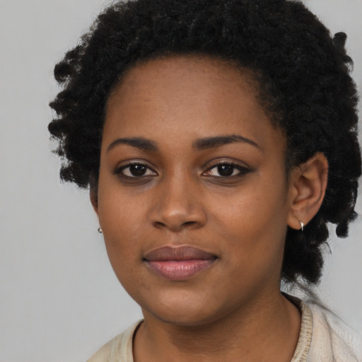 Joyful black young-adult female with short  black hair and brown eyes