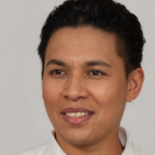 Joyful latino young-adult male with short  brown hair and brown eyes