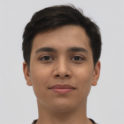 Joyful latino young-adult male with short  brown hair and brown eyes