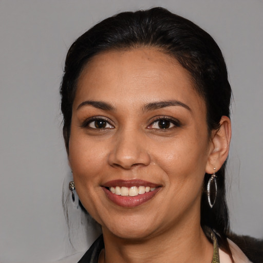 Joyful latino young-adult female with medium  black hair and brown eyes