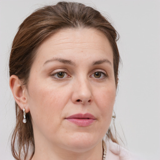 Joyful white adult female with medium  brown hair and grey eyes