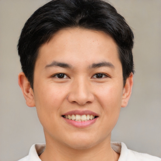 Joyful asian young-adult male with short  brown hair and brown eyes