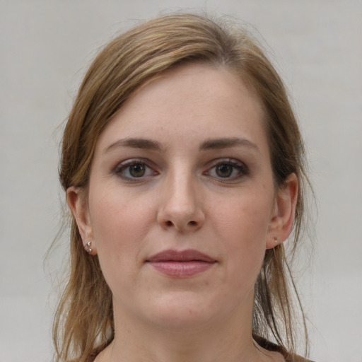 Joyful white young-adult female with medium  brown hair and grey eyes