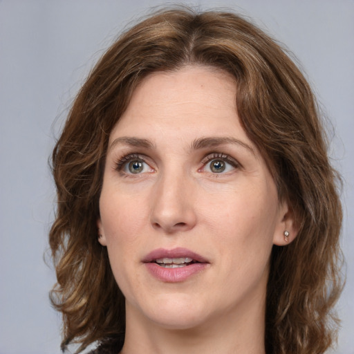 Joyful white young-adult female with medium  brown hair and green eyes