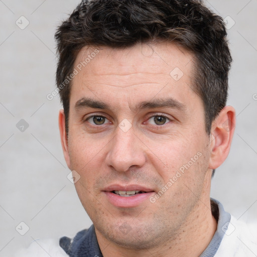 Joyful white adult male with short  brown hair and brown eyes