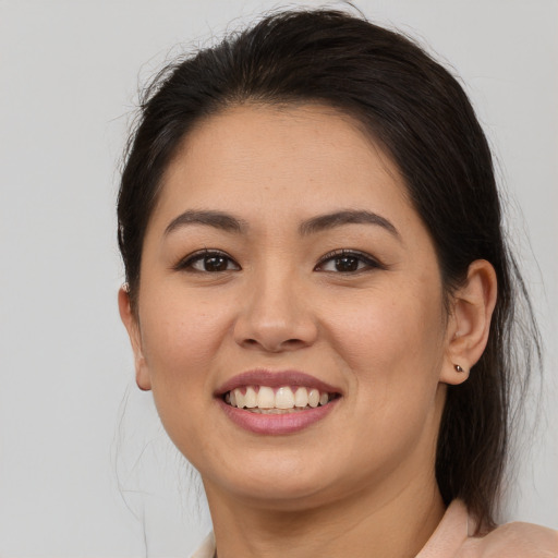 Joyful latino young-adult female with medium  brown hair and brown eyes