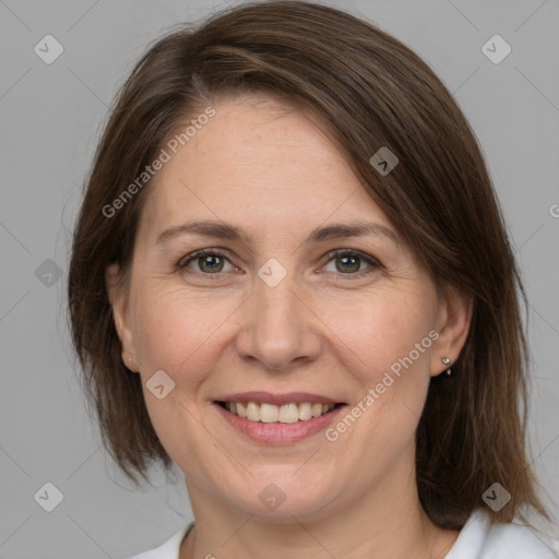 Joyful white adult female with medium  brown hair and grey eyes