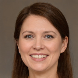 Joyful white adult female with long  brown hair and brown eyes