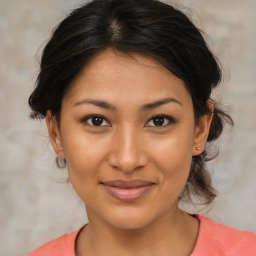 Joyful latino young-adult female with medium  brown hair and brown eyes