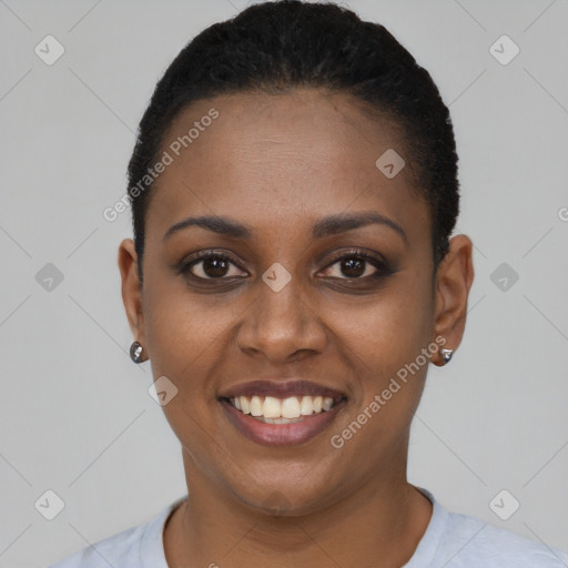 Joyful black young-adult female with short  black hair and brown eyes