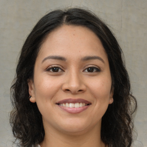 Joyful white young-adult female with long  brown hair and brown eyes