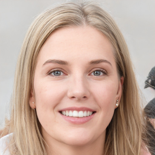 Joyful white young-adult female with long  brown hair and grey eyes