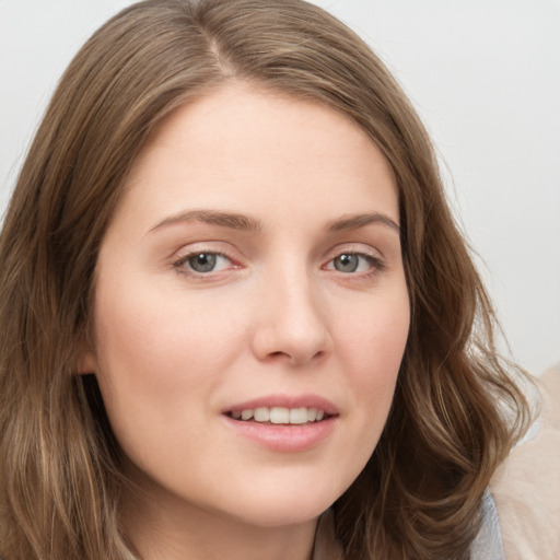 Joyful white young-adult female with long  brown hair and green eyes