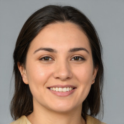 Joyful white young-adult female with medium  brown hair and brown eyes