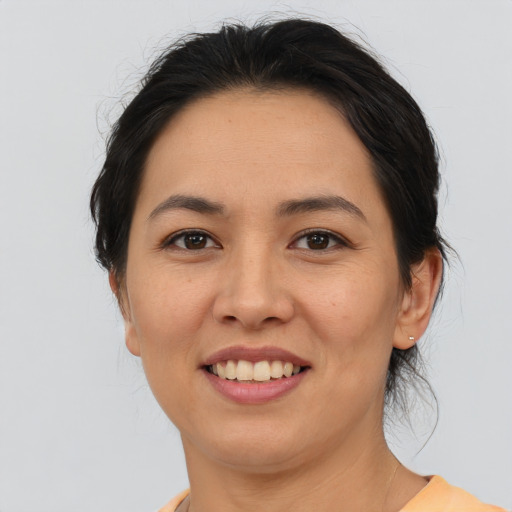 Joyful asian young-adult female with medium  brown hair and brown eyes