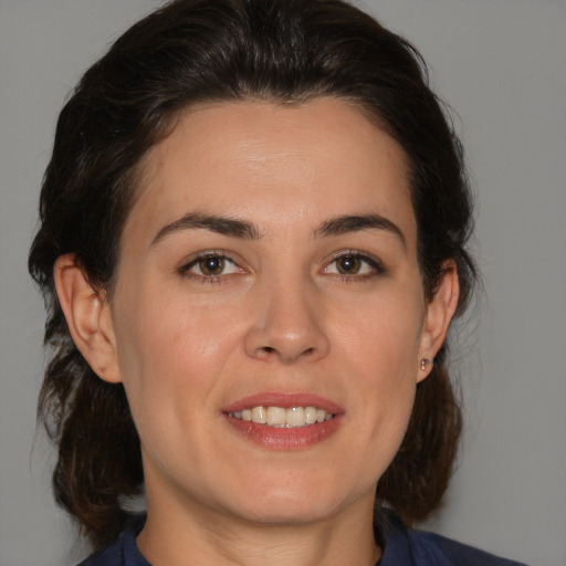 Joyful white young-adult female with medium  brown hair and brown eyes