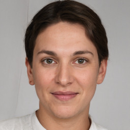 Joyful white young-adult female with short  brown hair and grey eyes