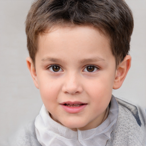 Joyful white child male with short  brown hair and brown eyes