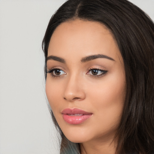 Joyful latino young-adult female with long  black hair and brown eyes