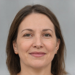 Joyful white adult female with medium  brown hair and grey eyes