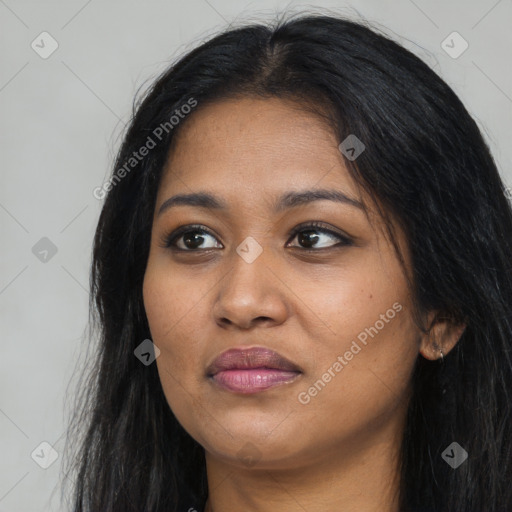 Joyful black young-adult female with long  black hair and brown eyes