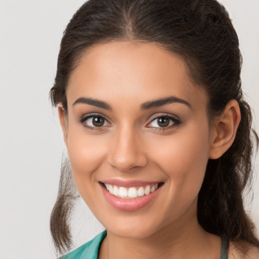 Joyful white young-adult female with long  brown hair and brown eyes