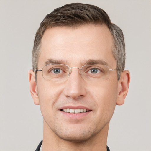 Joyful white adult male with short  brown hair and grey eyes