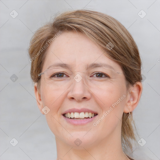 Joyful white adult female with medium  brown hair and grey eyes